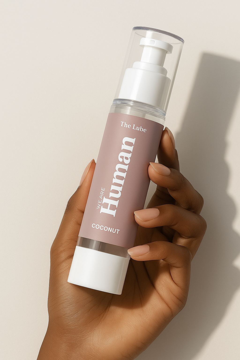 Hand holding The Lube – Coconut, water-based personal lubricant by We Are Human